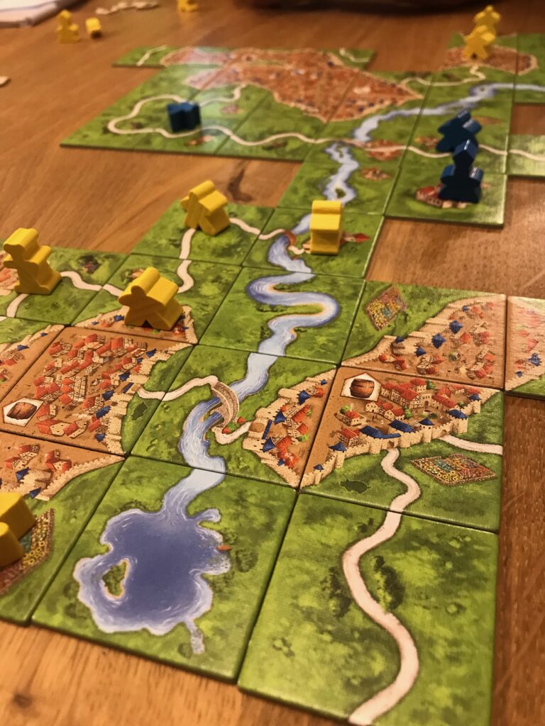 A close up view of the river tiles in the middle of a game of Carcassonne.