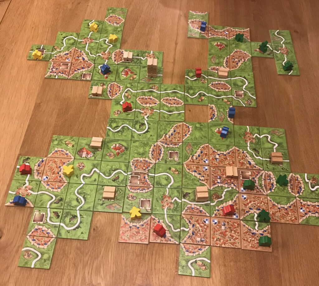 A plan view of a game of Carcassonne with several towers and tower base tiles visible.