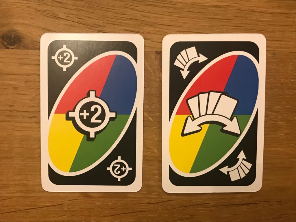 Two cards from Uno All Wild. On the left a targeted plus 2 card, and on the right a forced swap card.