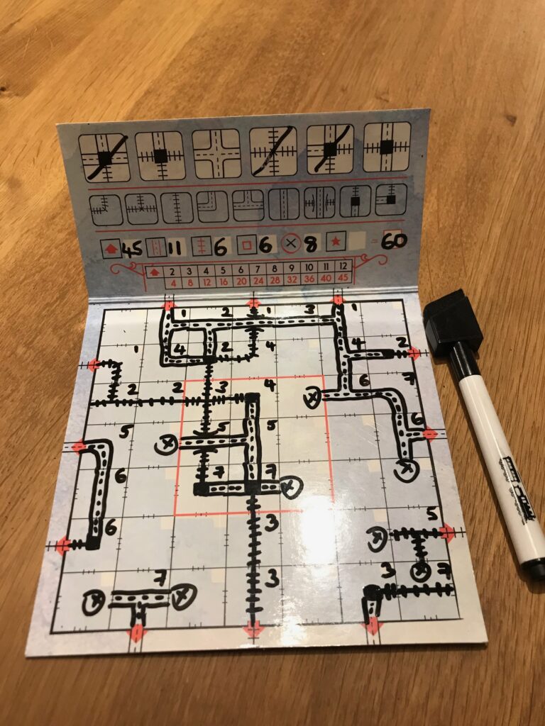 A completed game board for a regular game of Railroad Ink using the Deep Blue version of the game.