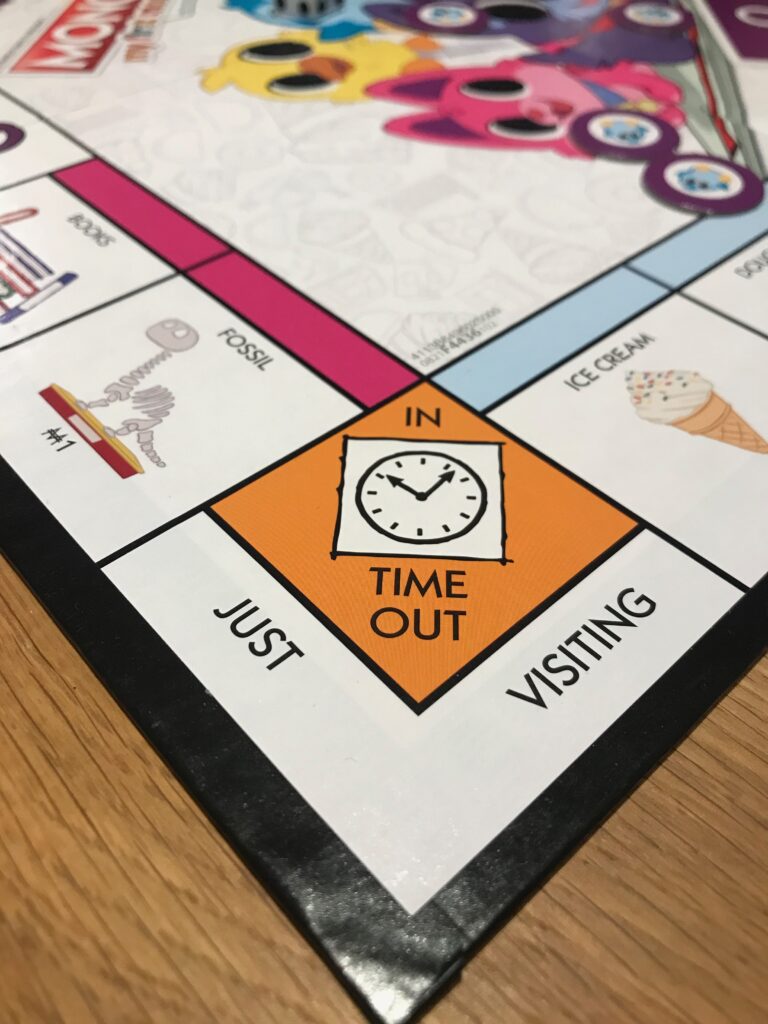 The Time Out square. This looks very like the usual Jail square on the Monopoly board with the same colours, but a picture of a clock instead of bars.
