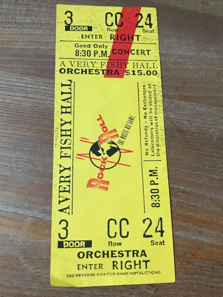 A large cardboard concert ticket - with the game instructions printed on the back.